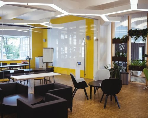 View of empty modern office with sofa, table, chair